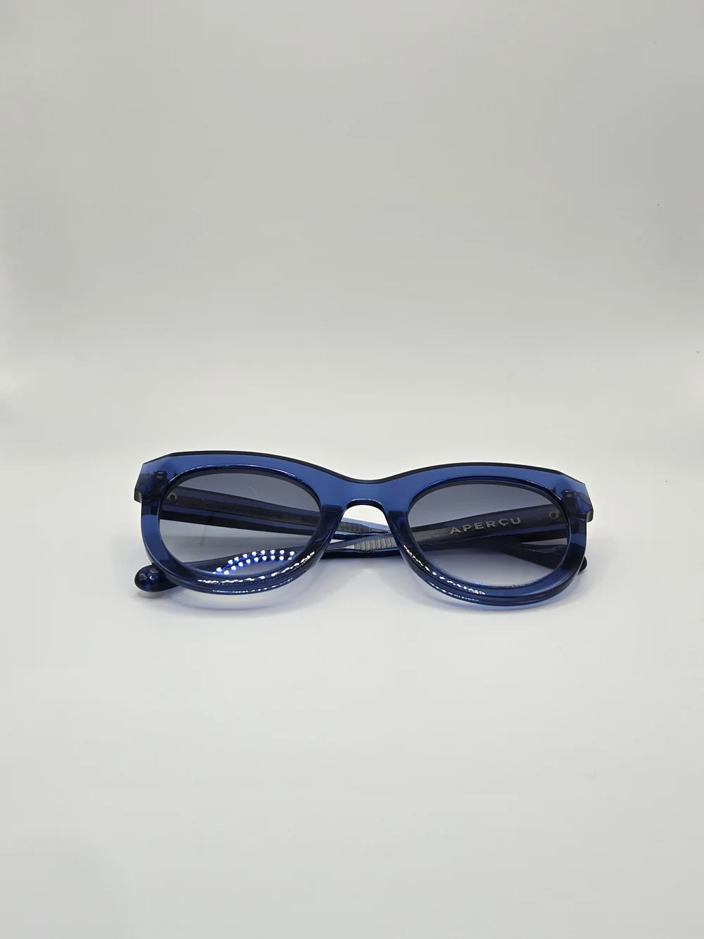 Aperçu sunglasses featuring a bold acetate frame and gold tone branding
